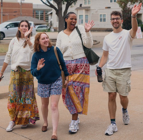 Group of university students sitting at table.