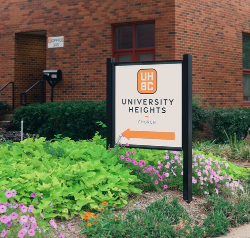 Front entrance sign of UHBC in a beautiful flower bed.