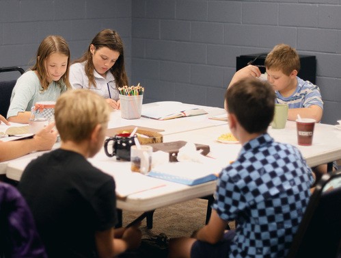 Group of kids sitting at a table during Sunday School.
