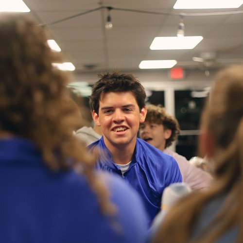 Man holding toddler and smiling at the camera.