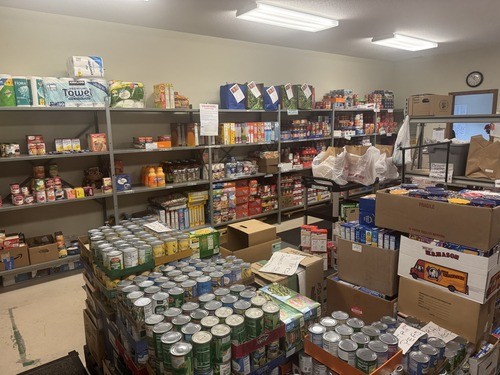 Shelves of food for the MedinaUMC Food Pantry including Tuna and Tuna Helper, canned chicken, tomato sauce and other food.