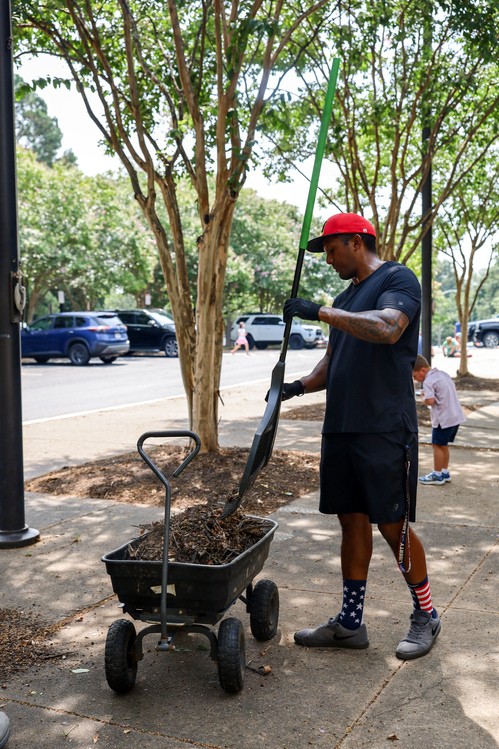 Restoration City Church volunteers of all ages working together to unload soil during a local community service project.
