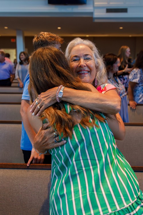 woman hugging another woman