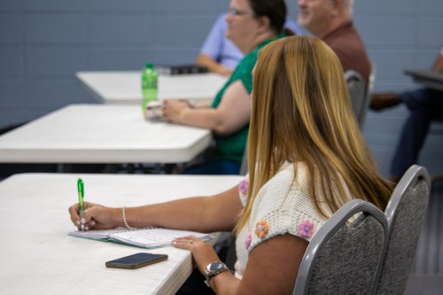 woman taking notes during Sunday school