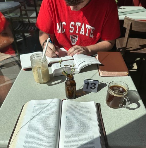 Students reading the Bible together.
