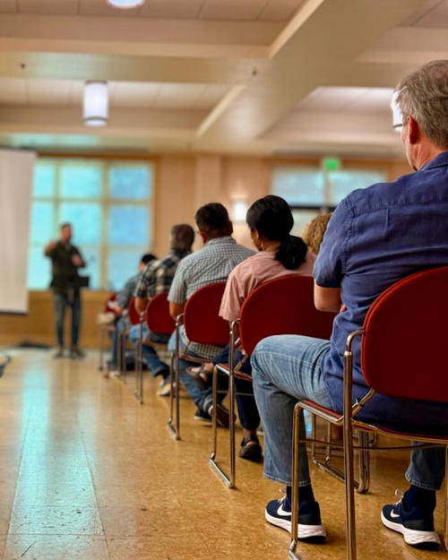 People sitting in chairs listening to the sermon