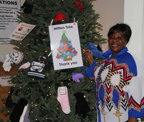 Woman standing by a Christmas Tree