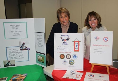 Two women with a table display