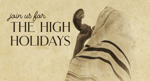 A cloaked figure playing a shofar.  